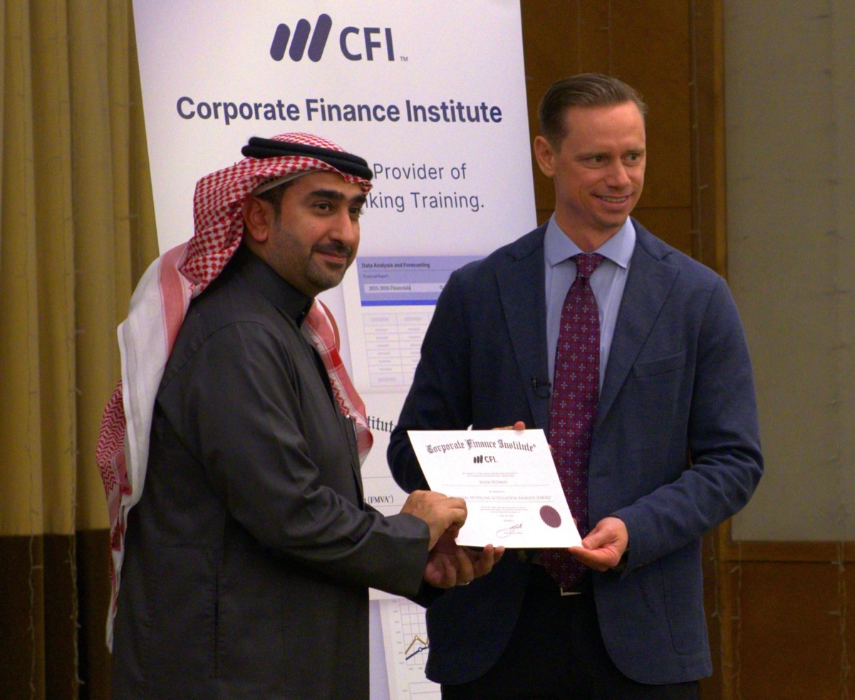 A CFI graduate receiving their certificate at the Dammam, Saudi Arabia certification ceremony