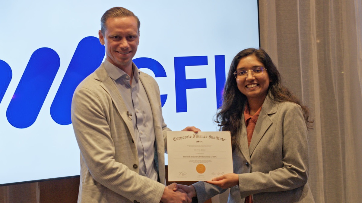 A CFI graduate receiving their certificate at the Dubai, UAE certification ceremony