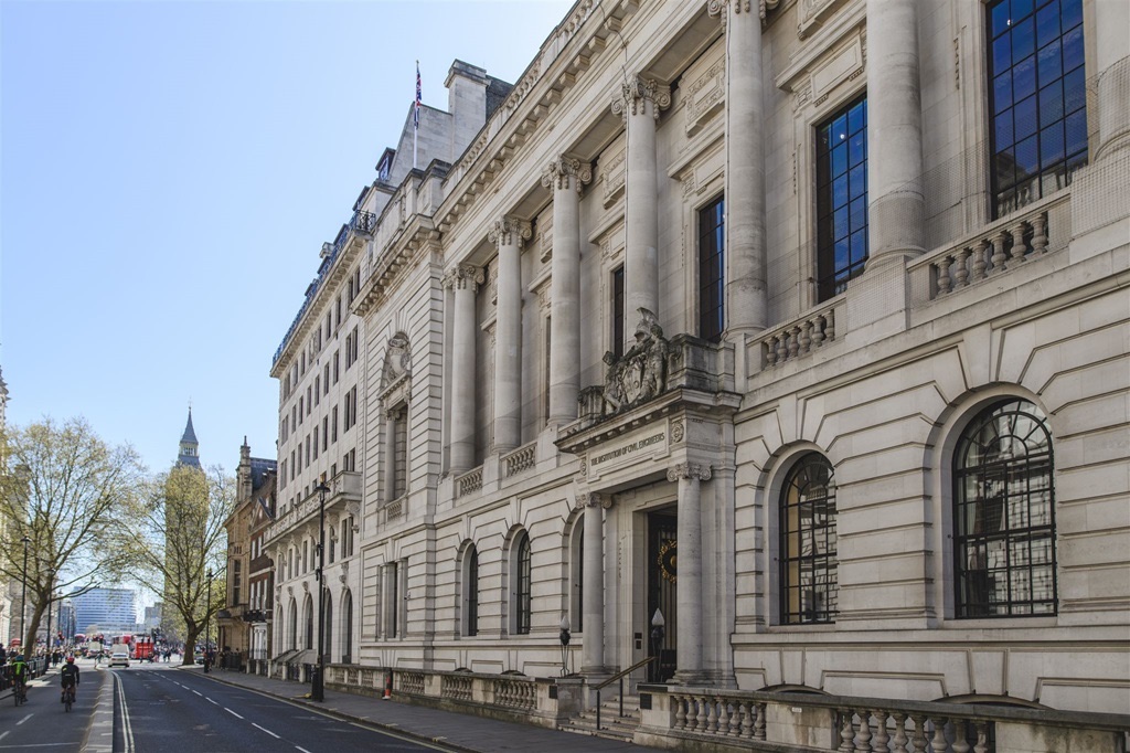 The stone front of One Great George Street in Westminster, with Big Ben in the distance